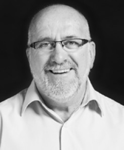 Image of a man with a grey beard and glasses